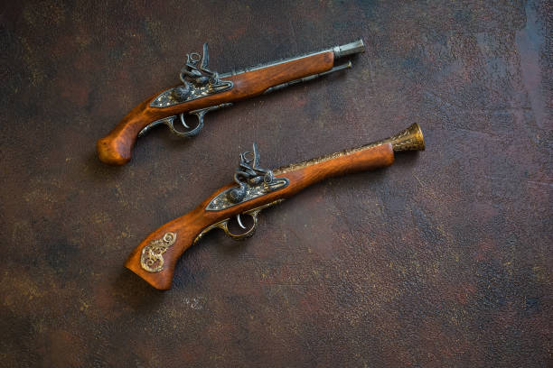 istock Two vintage duel pistols on wooden background 1039950126