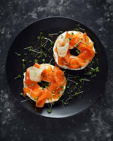 Smoked salmon bagel toasts with soft cheese, cucumber ribbons and cress salad.