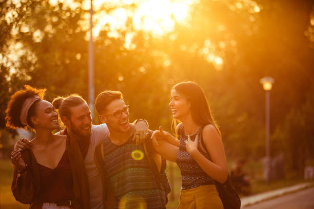 Cropped shot of four joyful young friends having fun on their way to the festival venue