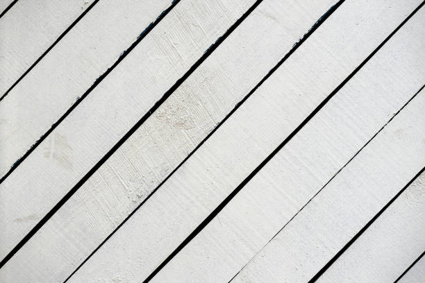 istock White painted wooden surface close-up. Rustic natural wooden diagonal planks with cracks, scratches for modern design, patterns, extured background 1039970360