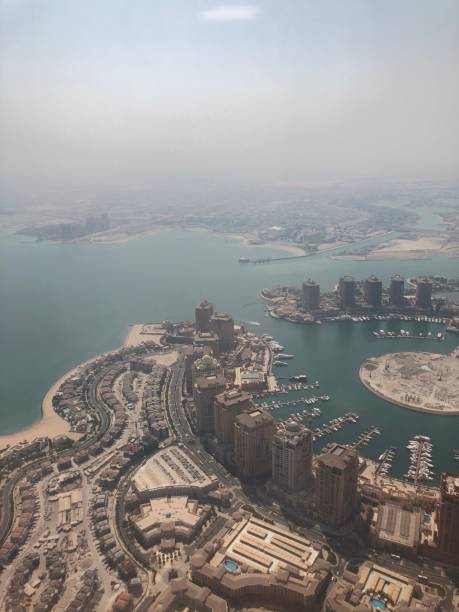 istock Doha, Qatar seen from an airplane window, aerial view, sky, middle east 1039984290