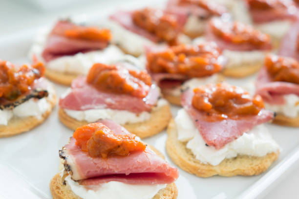 istock Canape with smoked meat, cheese and tomato sauce 1039990664