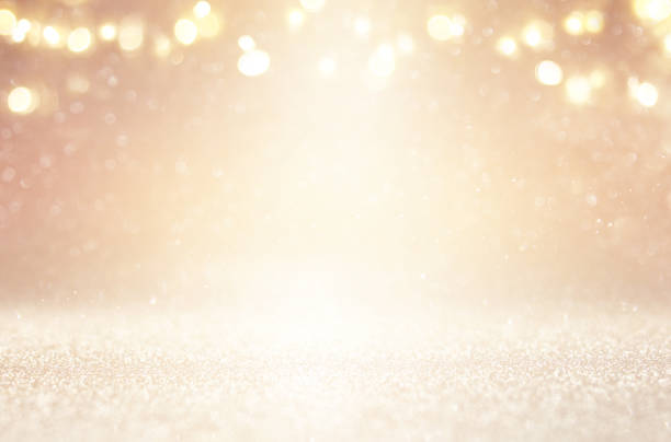 istock glitter vintage lights background. silver, gold and white. de-focused. 1039995750