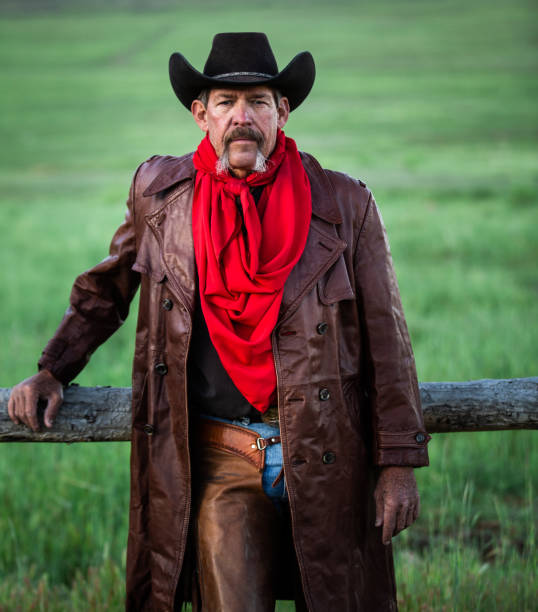 istock Senior cowboy leaning against fence 1040015160