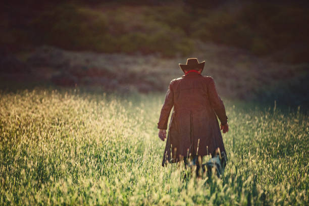 istock Senior cowboy walking on grass 1040015248