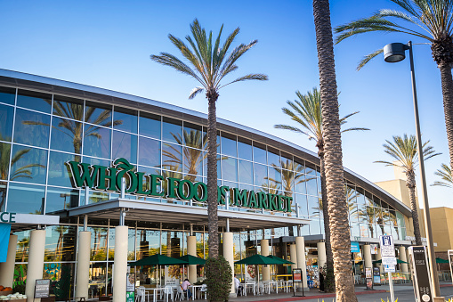 Whole Foods Market in Irvine, California. People can be seen in the outdoor seating area.