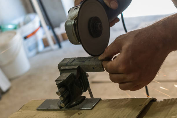 istock Men cuts a small metal sheet with an electric grinder 1040023692