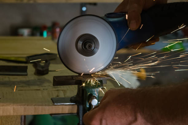 istock Men cuts a small metal sheet with an electric grinder 1040023714