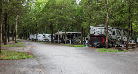 Lebanon, TN, USA-28 June 18:  A line of class A RVs, in Cedars of Lebanon State Park campground, on a rainy day.