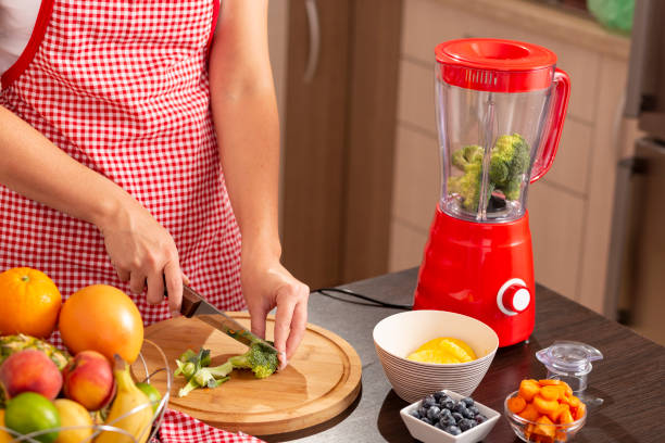 istock Woman cutting broccoli for vegetable broth 1040042694