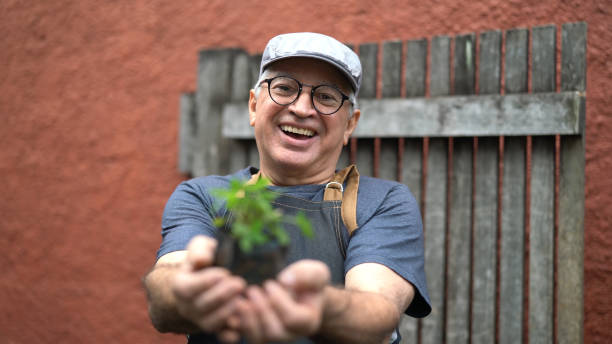 istock Portrait of Farmer Showing Plants 1040054734