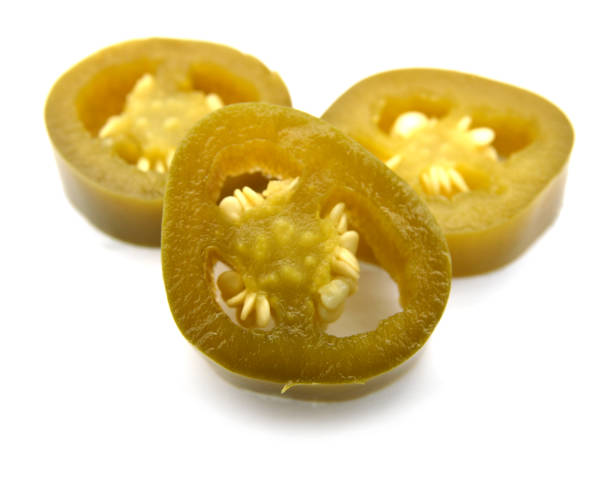 istock two pickled sliced green jalapeno peppers on white background 1040063056