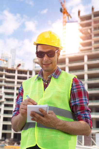 istock Young Engineer portrait with construction site and crane background. 1040075716