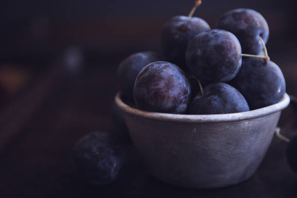 istock Fresh Damson Plums In An Antique Tin Cup 1040076342