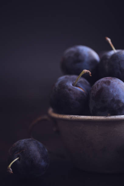 istock Fresh Damson Plums In An Antique Tin Cup 1040076352