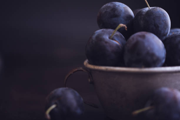 istock Fresh Damson Plums In An Antique Tin Cup 1040076368