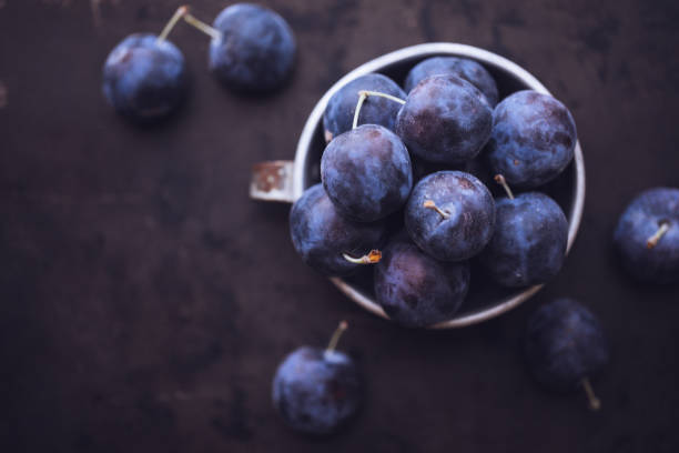 istock Fresh Damson Plums In An Antique Tin Cup 1040076426