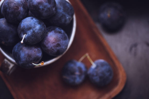 istock Fresh Damson Plums In An Antique Tin Cup 1040076466