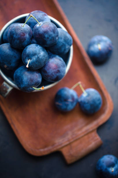 istock Fresh Damson Plums In An Antique Tin Cup 1040076502