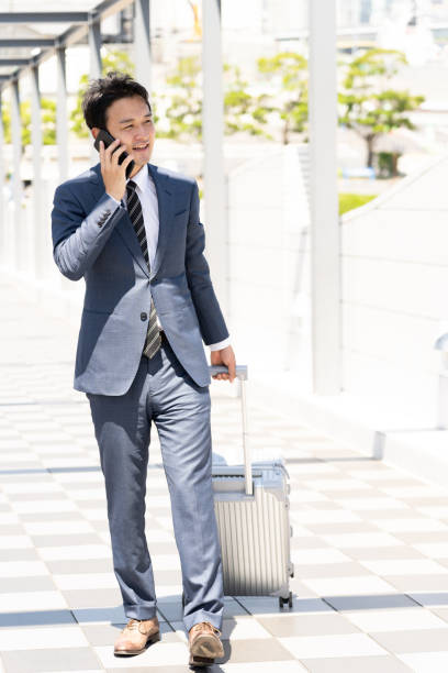 istock asian businessman walking with suitcase 1040078804