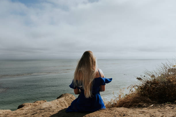 istock A woman sitting alone at the beach 1040079056