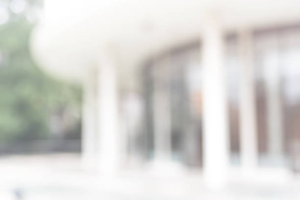 istock Office or university building blur background exterior view with blurry empty lobby space, entrance hall glass wall window and light bokeh 1040084194