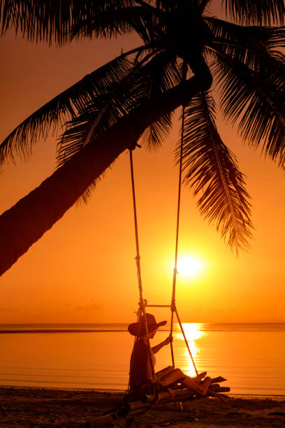 istock Woman at sunset swing 1040084258