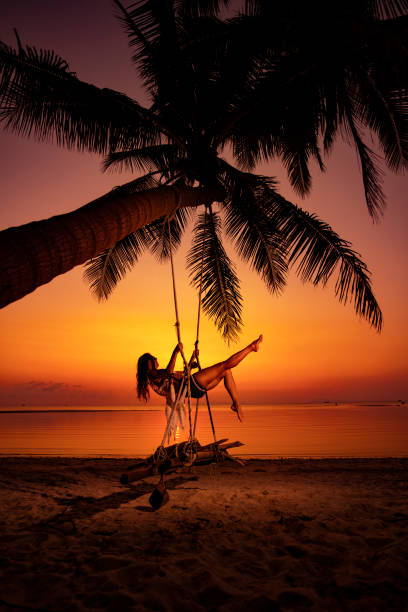 istock Woman at sunset swing 1040084276