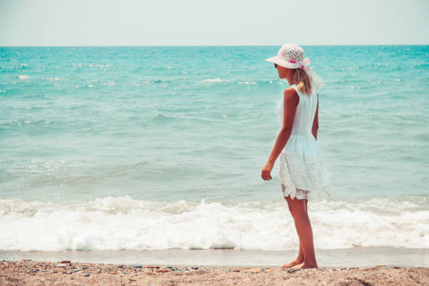 istock Lonely young woman walking on the beach 1040084466
