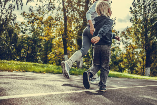 istock woman and boy running at the stadium 1040084636