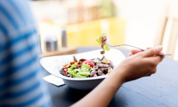 istock Woman is Eating Salad 1040084684