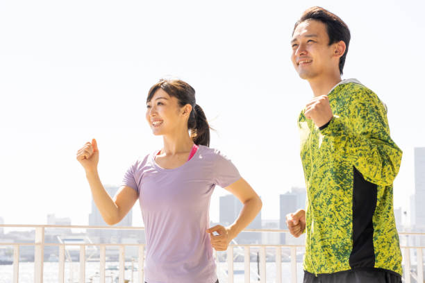 sporty asian people jogging sporty asian people jogging racewalking stock pictures, royalty-free photos & images