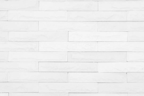 istock Seamless White pattern of decorative brick sandstone wall surface with concrete of modern style design decorative uneven have cracked realmasonry wall of multicolored stones or blocks with cement. 1040090152