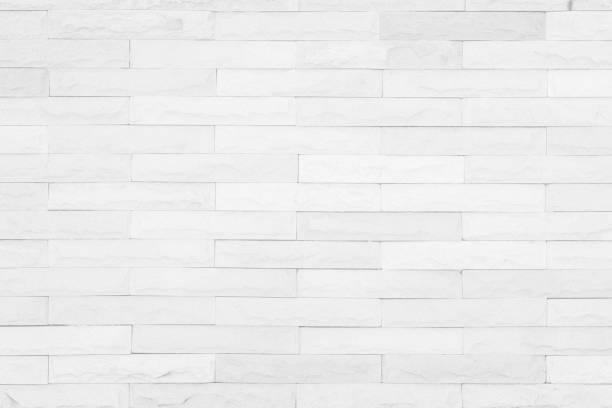 istock Seamless White pattern of decorative brick sandstone wall surface with concrete of modern style design decorative uneven have cracked realmasonry wall of multicolored stones or blocks with cement. 1040090158