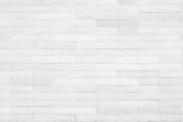 istock Seamless White pattern of decorative brick sandstone wall surface with concrete of modern style design decorative uneven have cracked realmasonry wall of multicolored stones or blocks with cement. 1040090160