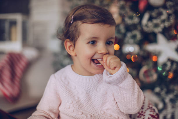 istock Child enjoying by Christmas tree 1040097538