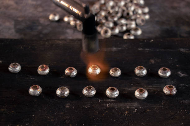 istock melting silver in craft jewelry making, handmade silverware process. 1040106378