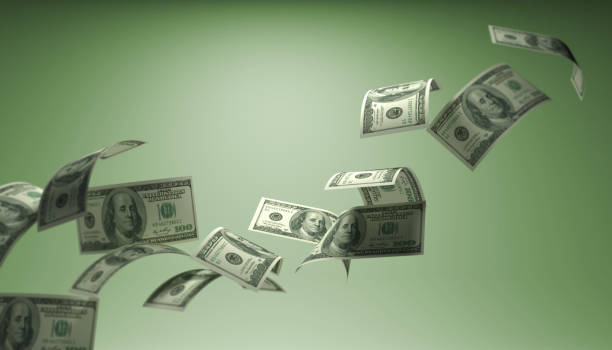 istock Dollar bills flying from left to right On green background 1040116336