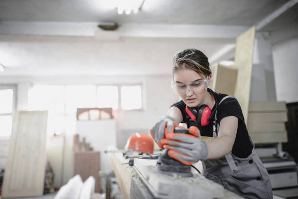 istock Cute Female Learning How To Sand A Wooden Plank 1040148090