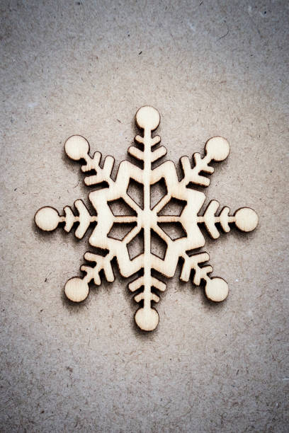 istock Wooden Decorative Snowflake on Craft Paper Background 1040174498