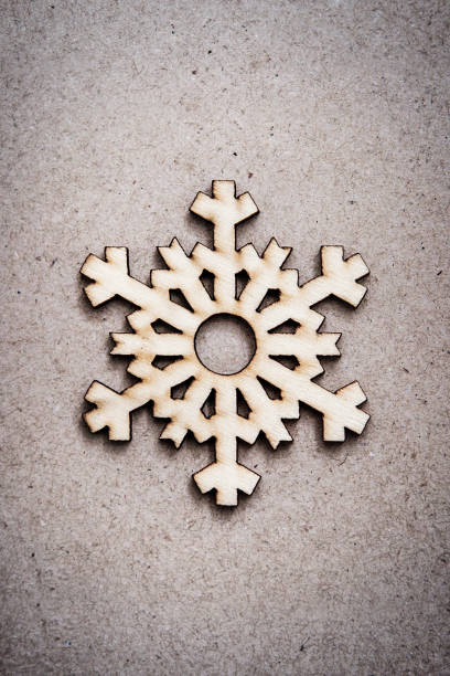 istock Wooden Decorative Snowflake on Craft Paper Background 1040174502