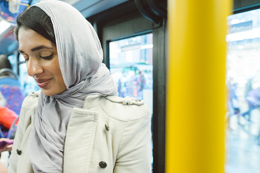 Beautiful woman on the bus wearing hijab.