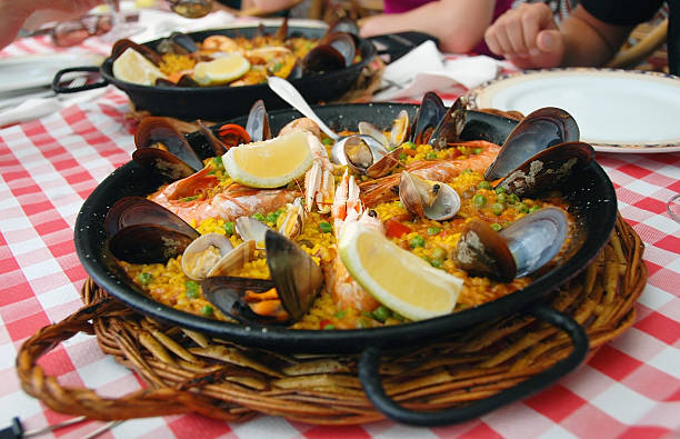 istock Paella in cast iron pan on red checked tablecloth 104020467