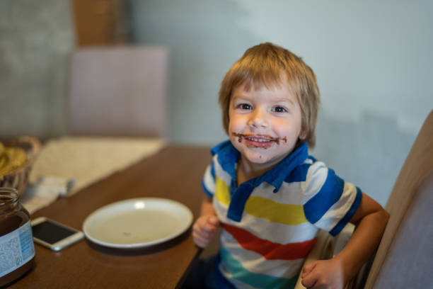 istock Cute little boy with chocolate mustache and beard. 1040205836