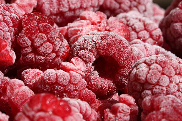 frozen raspberries stock photo