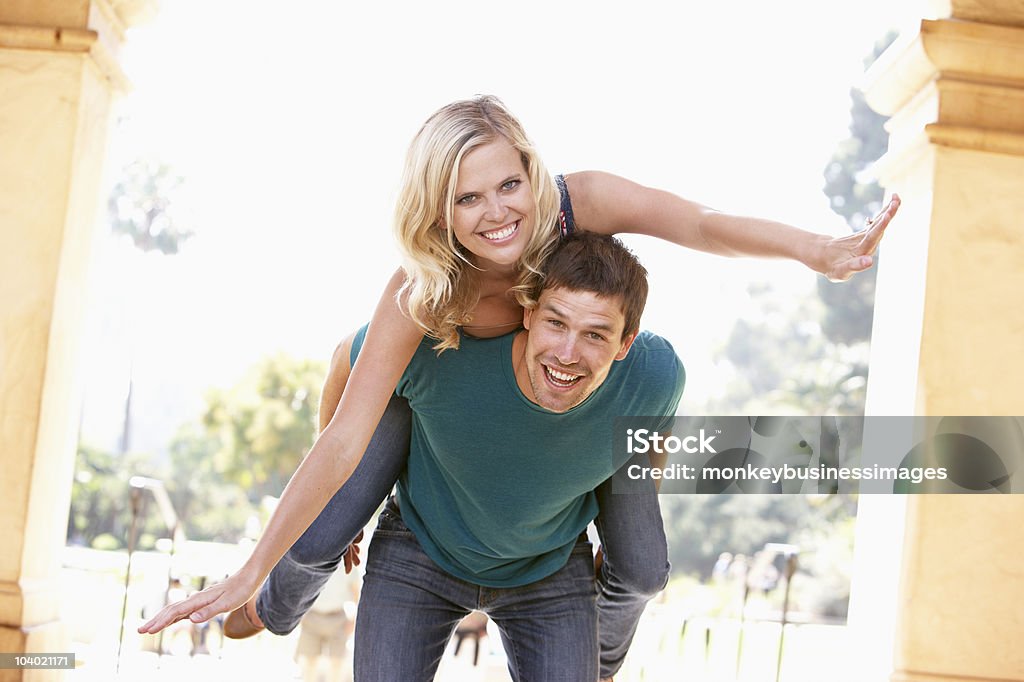 Young Man Giving Woman Piggyback  20-29 Years Stock Photo