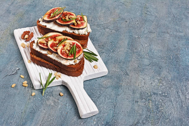 istock Vegetarian sandwich with figs, soft cheese, honey, nut and rosemary 1040213932