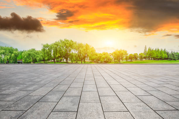 istock Empty square floor and green forest scenery at sunset 1040220942