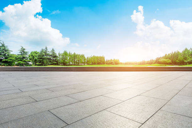 istock Empty square floor and green forest scenery at sunset 1040221488