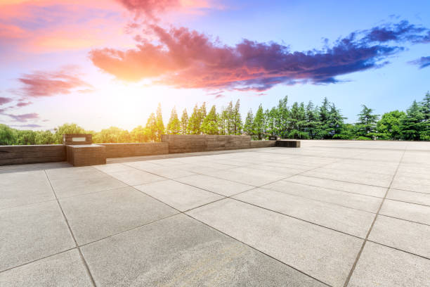 istock Empty square floor and green forest scenery at sunset 1040221822